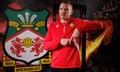 Paul Mullin poses in front of a Wrexham badge.