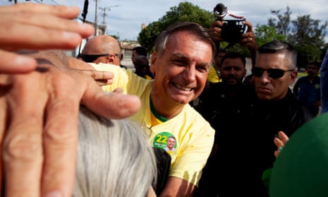 Liberal Party (PL) incumbent Jair Bolsonaro, who is seeking re-election, greets his supporters after casting his vote in the Vila Militar district on October 30, 2022 in Brasilia, Brazil.