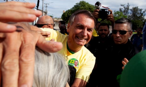 Brazilian Elections Live: Lula faces Bolsonaro in second round amid voter suppression fears | Brazil 1 Liberal Party (PL) incumbent Jair Bolsonaro, who is seeking re-election, greets his supporters after casting his vote in the Vila Militar district on October 30, 2022 in Brasilia, Brazil.