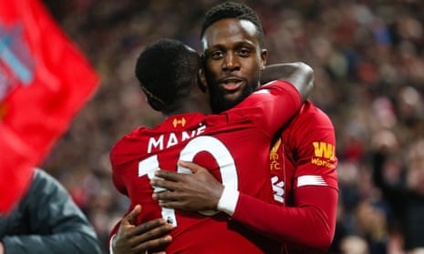 Divock Origi celebrates with Sadio Mane after opening the scoring at Anfield in the Merseyside derby. 