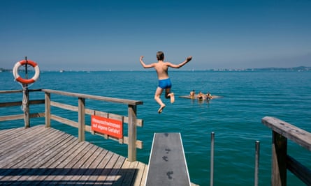 Boy jumping from a diving board into the Lake Constance, Bregenz, Austria