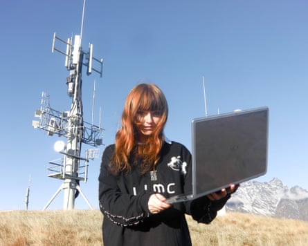 Australian musician Ninajirachi standing outside holding a laptop