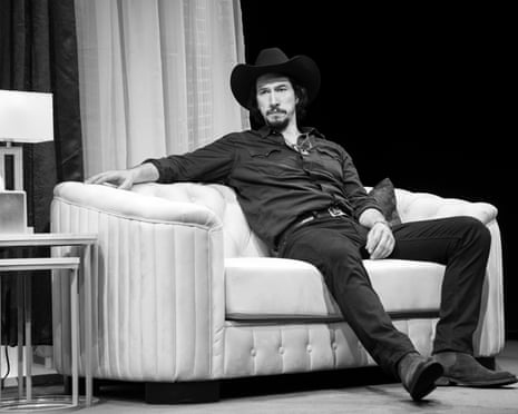 black and white photo of man sitting on sofa