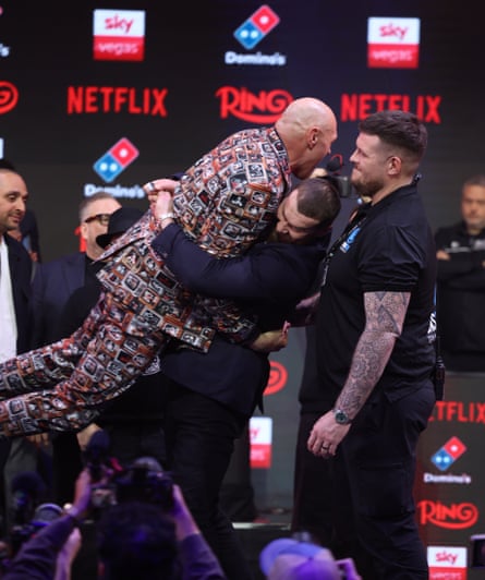 Tyson Fury is lifted into the air by Arslanbek Makhmudov while on stage