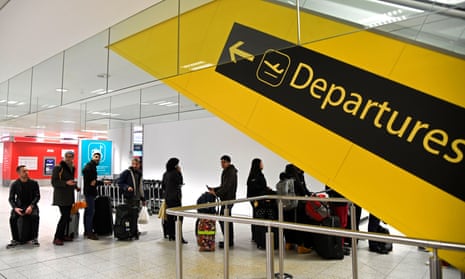Passengers wait in the South Terminal building at Gatwick shortly after the airport reopened to flights following its forced closure because of drone activity.