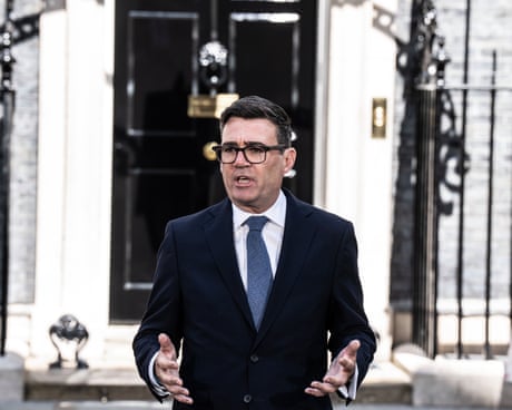Andy Burnham gestures as he speaks outside the black front door of No 10