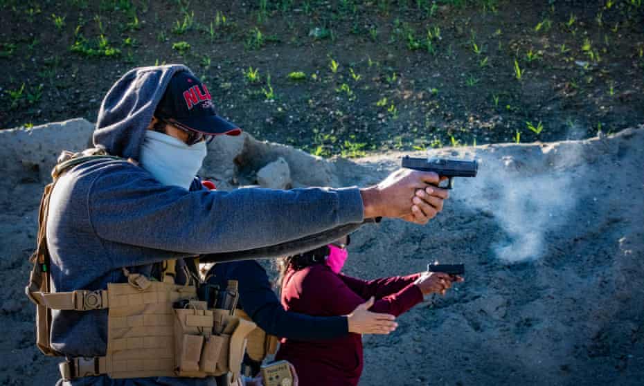 Two novice gun owners practice their marksmanship at a recent training for beginners organized by Black Gun Owners Association at the Richmond Rod & Gun Club.