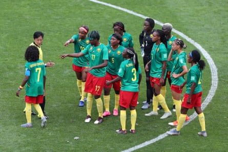 Irate Cameroon players surround referee Qin Liang during a Round Of 16 match between England and Cameroon at Stade du Hainaut.