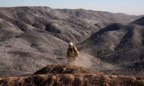 A firefighter looks for hotspots