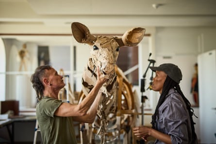 Lifesize herd of puppet animals begins climate action journey from Africa to Arctic Circle A man and a woman work on a puppet of a zebra