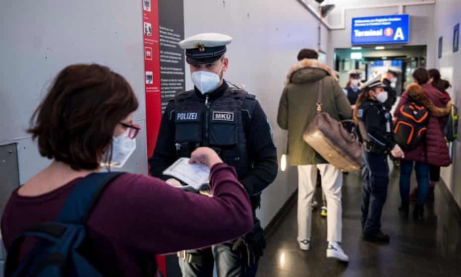 German border police check passengers arriving on a flight from Spain.