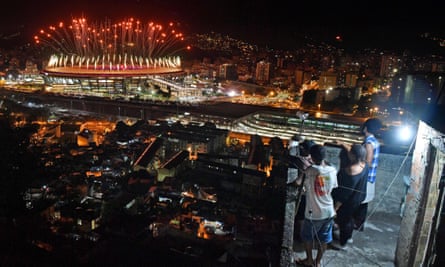 People watch fireworks in favela
