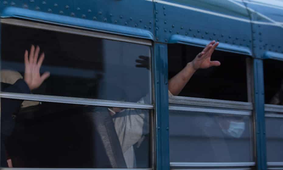 Guatemalans deported from the US, wave from a bus after arriving at La Aurora airport in Guatemala City last week. US border agencies quickly expelled about 600 child migrants in April after federal agencies began prohibiting asylum claims at the southern border, citing the coronavirus pandemic.