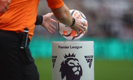 An official with a football at a Premier League match