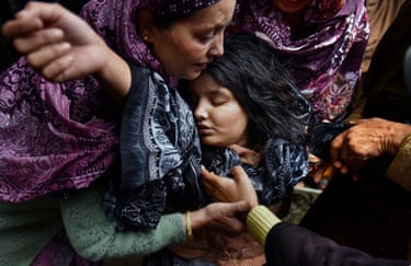 A woman holds an unconscious Sanam Bashir