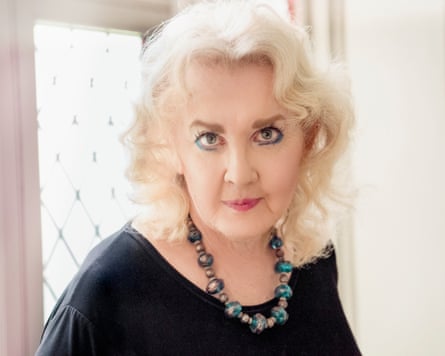 portrait of an older woman wearing a black top and necklace