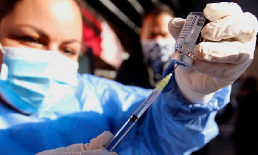 A nurse prepares a dose of the Oxford/AstraZeneca vaccine