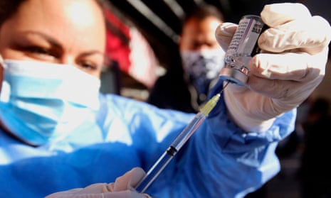 A nurse prepares a dose of the Oxford/AstraZeneca vaccine