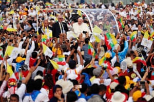 Pope Francis waves to the Catholic faithful as he arrives to lead mass at Kyite Ka San stadium