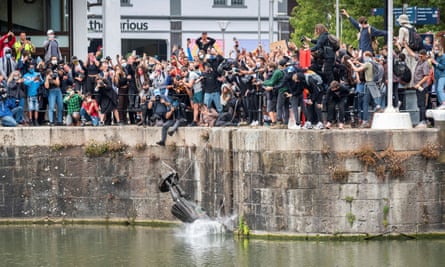 The statue of Edward Colston is thrown into Bristol harbour after protesters pulled it down.