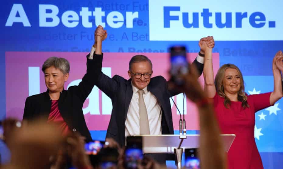 Labor party leader, Anthony Albanese, celebrates with his partner partner, Jodie Haydon, and Labor senate leader, Penny Wong at a Labor party event
