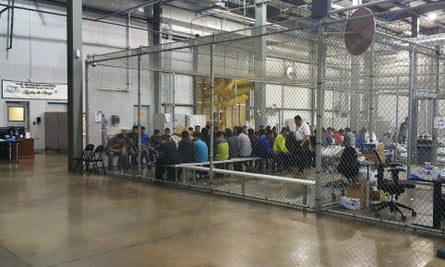 People who’ve been taken into custody related to cases of illegal entry into the United States, sit in one of the cages at a facility in McAllen, Texas, Sunday, 17 June.