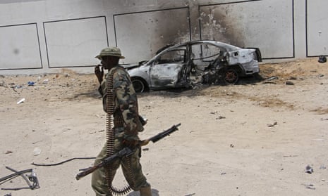 A Somali soldier near the wreckage of a car bomb in Mogadishu in April. There are several hundred US troops in Somalia helping the local military in its fight against al-Shabaab.
