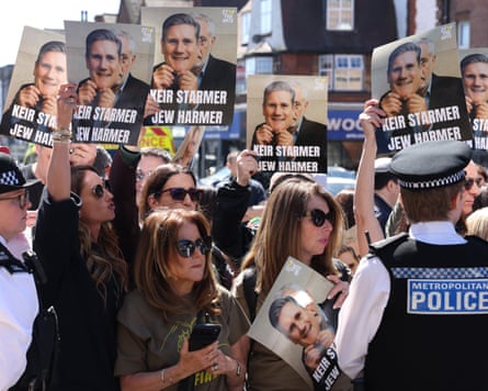 Protesters holding signs accusing Keir Starmer of not helping Jewish people