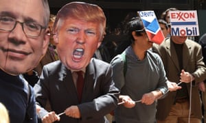 Protesters wear masks during a Trump Tower divestment ‘teach-in’ and tally in New York City on Tuesday.