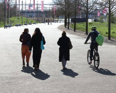 People walking through Queen Elizabeth Olympic park