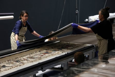 Museum staff work on the unveiling of the tapestry.