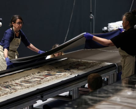 Museum staff work on the unveiling of the Bayeux tapestry.
