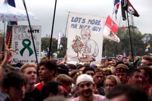 The crowd hold up banners at the Pyramid stage as they wait for Jeremy Corbyn to appear on stage