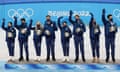 Alexa Knierim, Brandon Frazier, Madison Chock, Evan Bates, Karen Chen, Nathan Chen, Vincent Zhou, Madison Hubbell, Zachary Donohue of the United States celebrate during the figure skating team event flower ceremony on day three of the 2022 Beijing Winter Olympics.