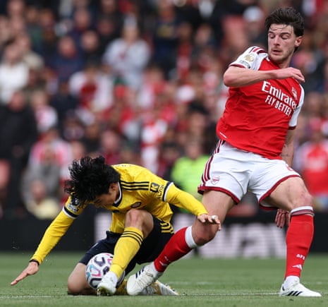 Leeds United's Ao Tanaka (left) tackles Arsenal's Declan Rice.