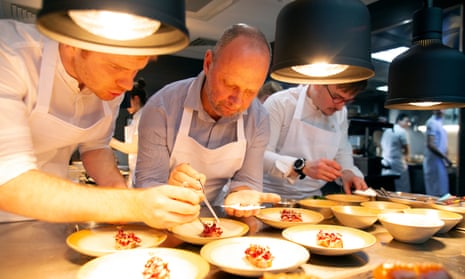 Simon Rogan (centre) helps to plate up food