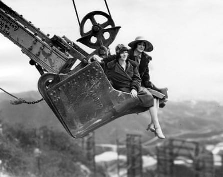 Two women suspended above the Hollywood sign on a steam shovel around 1924.