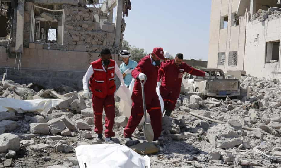 Yemeni Red Crescent workers remove the body of a casualty following a Saudi-led airstrike in Dhamar.