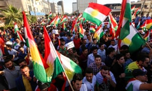 Iraqi Kurds wave flags of Iraqi Kurdistan and shout slogans during a demonstration outside the UN Office in Erbil.