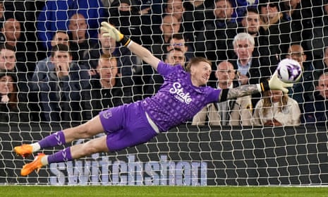 Pickford dives for a shot from Luton Osho that sails wide.