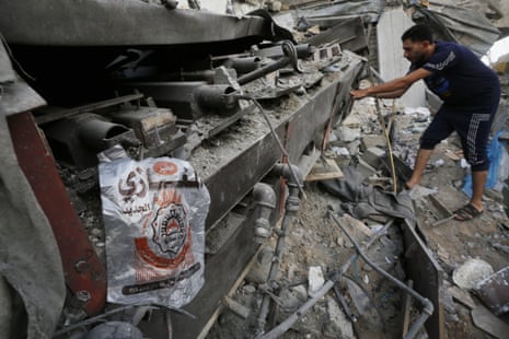 Palestinians try to salvage their belongings from the building containing the al-Magazi bakery, destroyed in an Israeli airstrike.