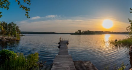 Scenic view of lake against sky during sunset, large sun on the horizon