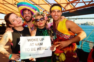 revellers hold a sign saying 'Woke up at 4am to be here'