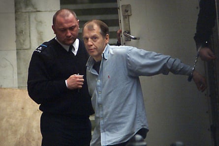 Michael Stone being led from a van in handcuffs.