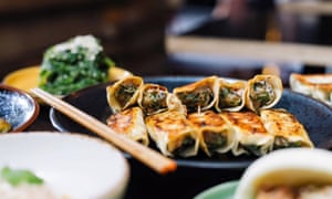 A plate of dumplings with a chopstick on the dise at ShanDong MaMa, Melbourne, Australia.