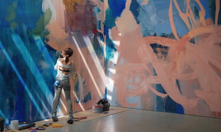 Megan Rooney at work on her mural Echoes & Hours, 2024.
