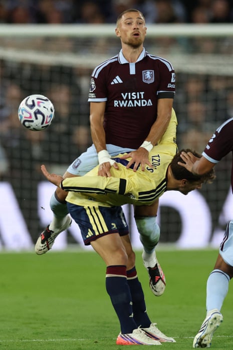 Aston Villa's Polish defender Matty Cash vies with Arsenal's Greek striker Christos Tzolis.
