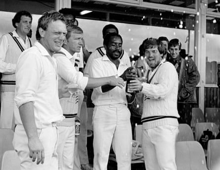 Roland Butcher and Middlesex captain Mike Gatting get the bubbly flowing after the club seal the 1985 County Championship title