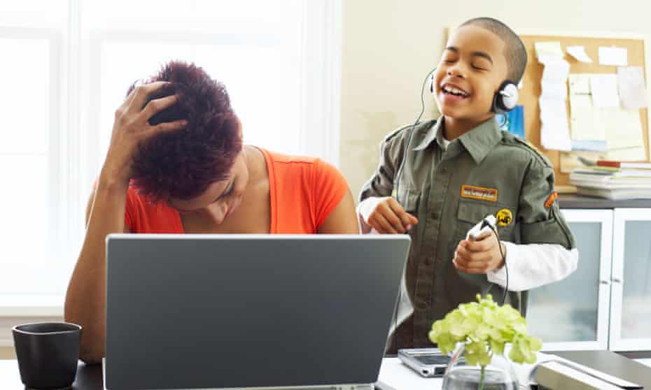Woman working from home while looking after child