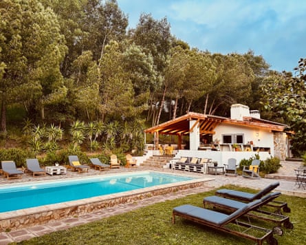 View of the outdoor pool and buildings at Quinta Camarena in Portugal, which is an eco retreat that reflects its owners’ backgrounds in the visual arts.